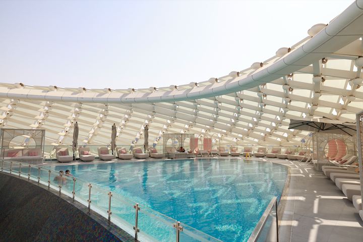 The Wet Deck pool by day, under the hotel's white gridshell