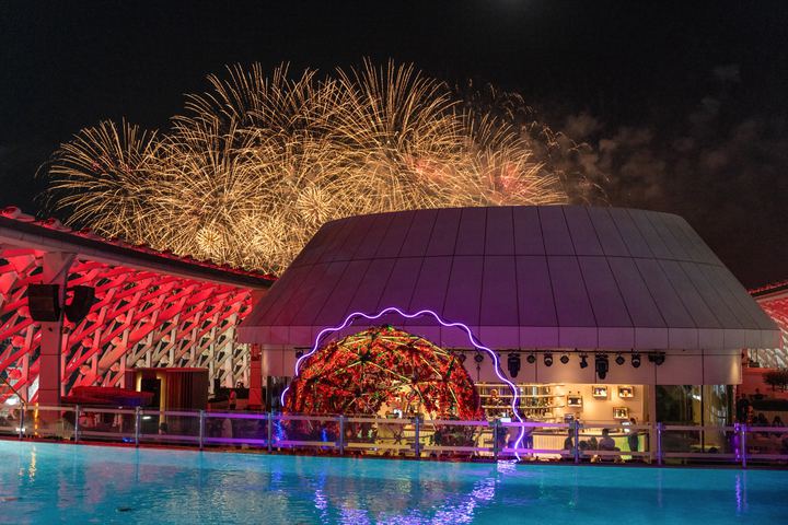 Fireworks over the rooftop dome and pool at night