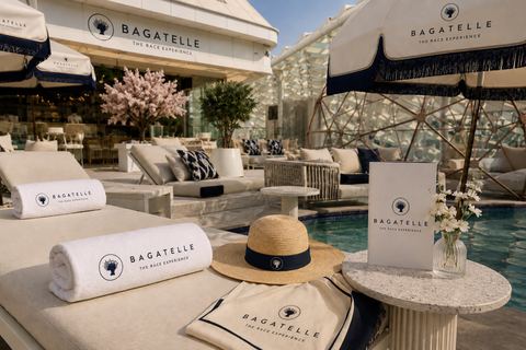 A Bagatelle-branded poolside cabana with towels and a sun hat